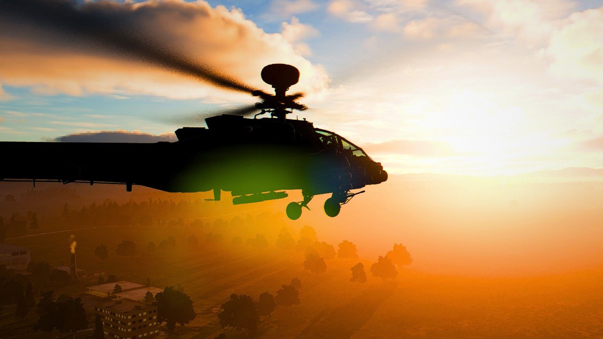 An AH-64D Apache low over the treeline at dusk
