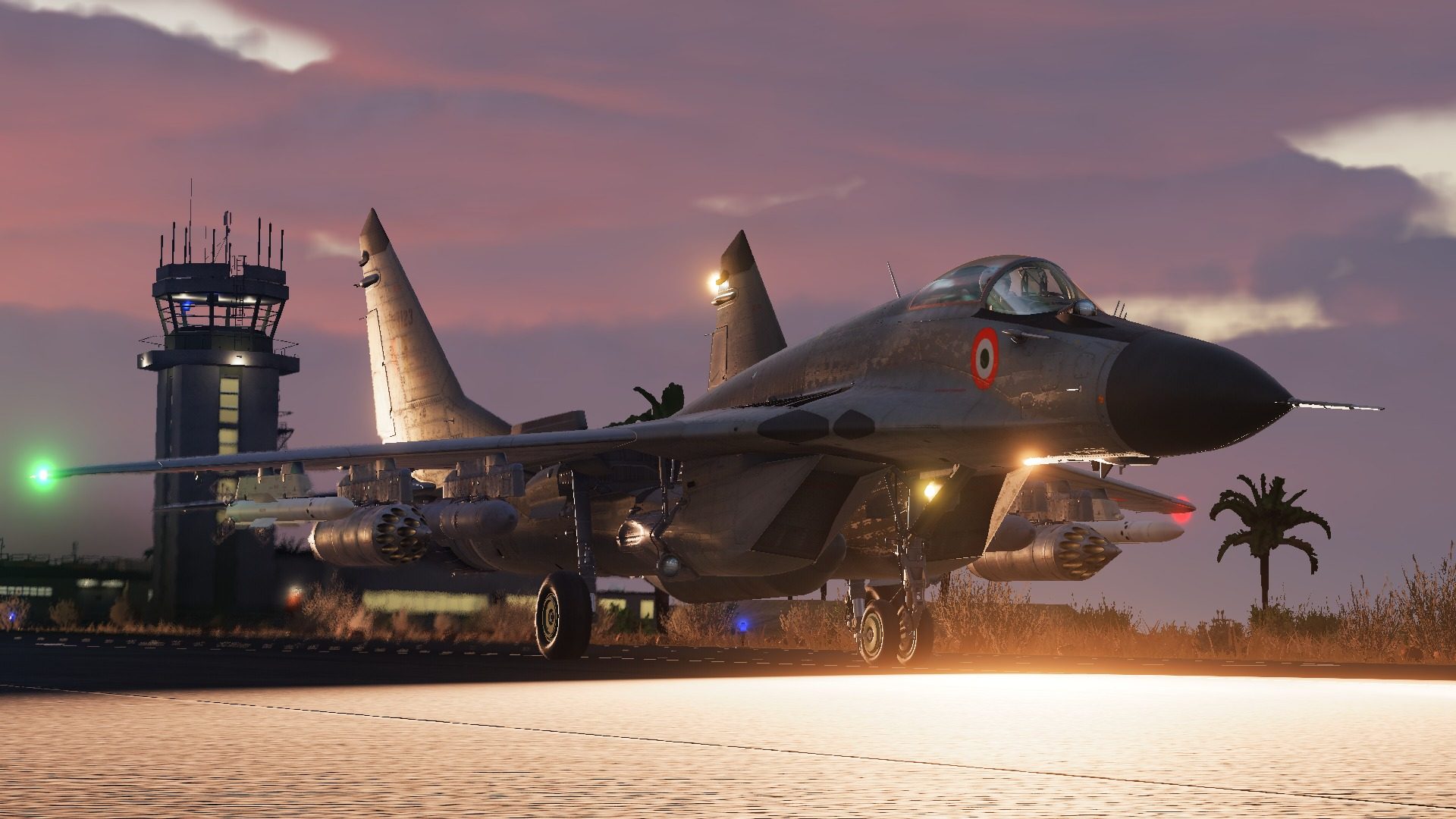 A MiG-29 Fulcrum parked by the tower at dusk