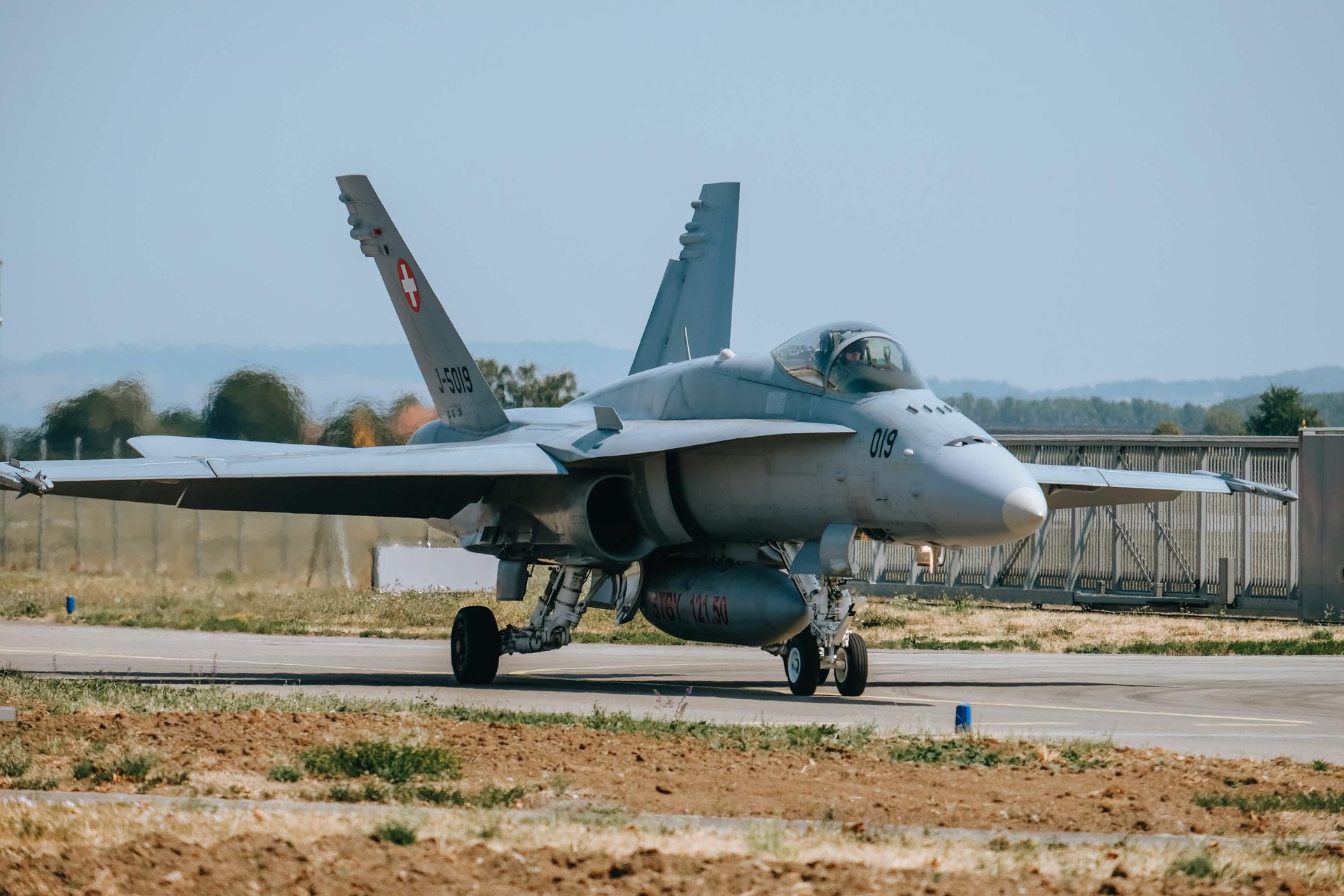 An F/A-18C Hornet taxiing on the ramp