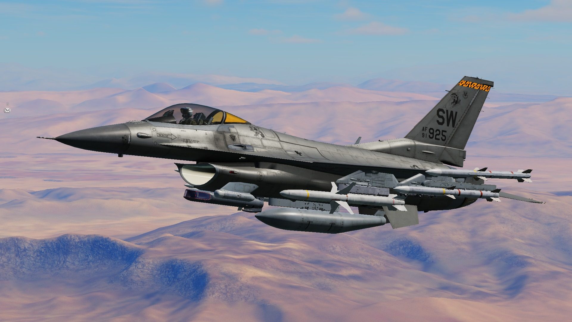 An F-16C over desert mountains