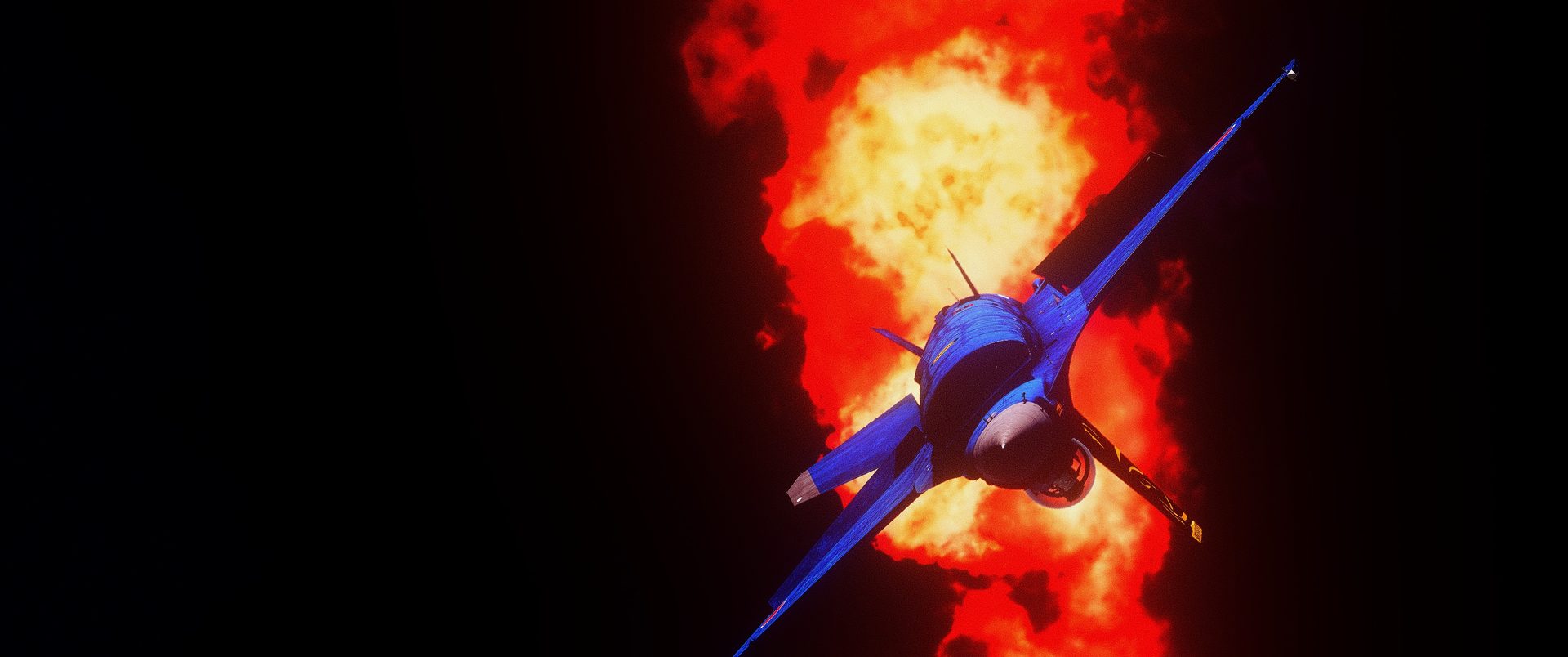 An F-16C pulling up in front of an explosion