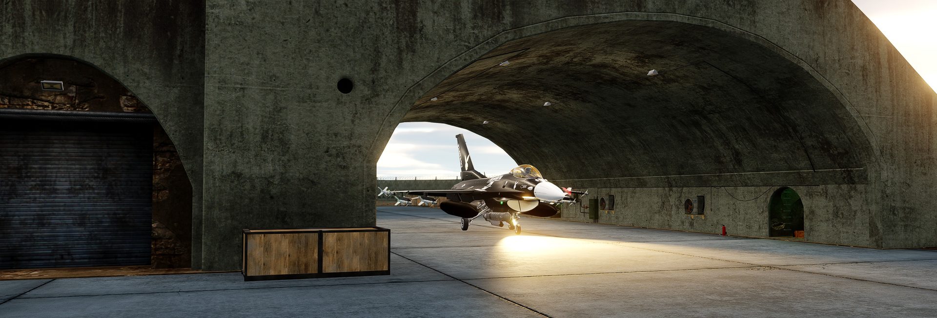 An F-16C taxiing out of a hardened aircraft shelter